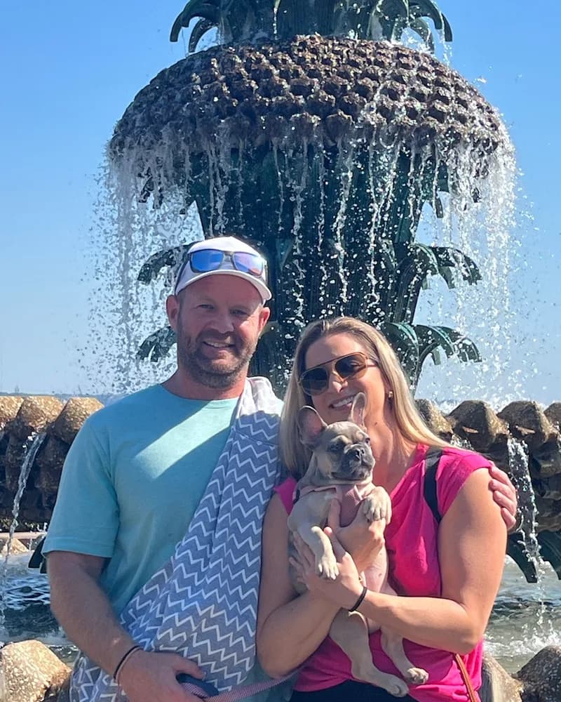 Chris, owner of Holy City Web Design, with his girlfriend and their French bulldog at the Pineapple Fountain in Charleston