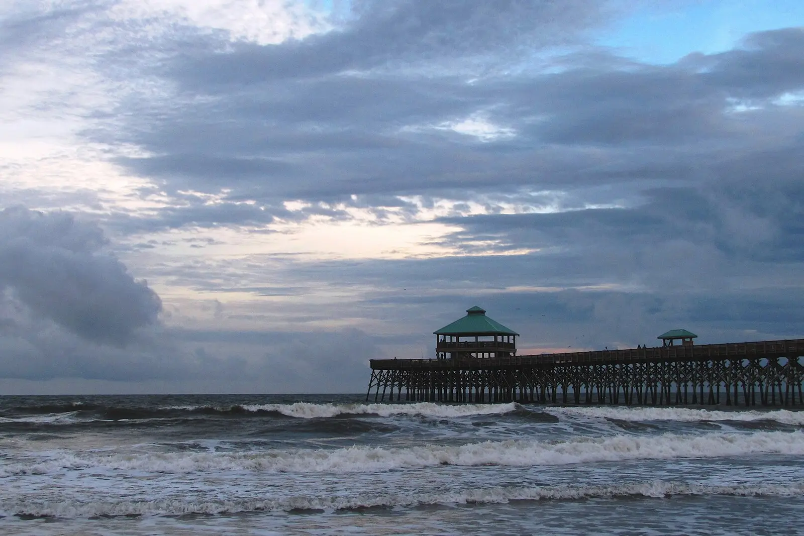 Waves at the Folly Beach pier under a stormy sky, Folly Beach, SC